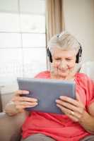 Happy senior woman listening to music