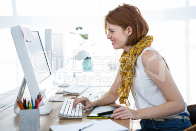 smiling hipster business woman typing on her computer