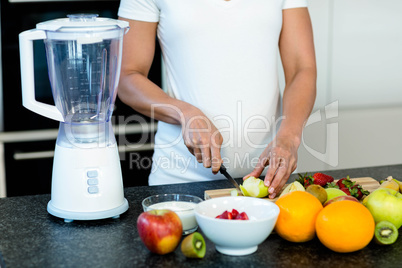 Pregnant woman cutting fruits