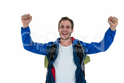 Backpacker raising his arms