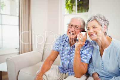 Senior couple talking on mobile phone