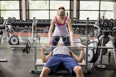 Trainer woman helping athletic man