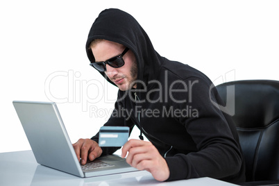 Man in black hoodie doing online shopping