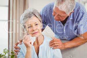 Senior man talking to upset senior woman