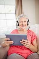 Happy senior woman listening to music