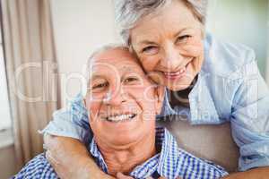 Senior woman embracing man at home