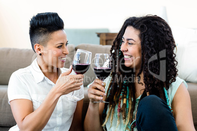 Lesbian couple toasting wine glasses