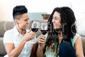 Lesbian couple toasting wine glasses