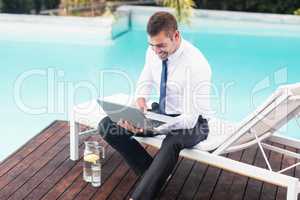 Smarty dressed man using laptop