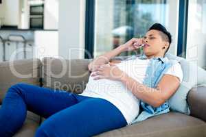 Pregnant woman relaxing on sofa