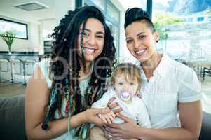 Portrait of lesbian couple with their baby