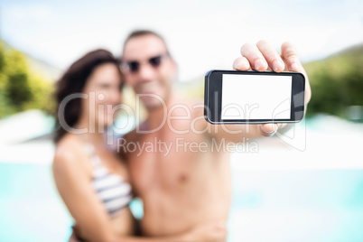 Young couple taking selfie with mobile phone