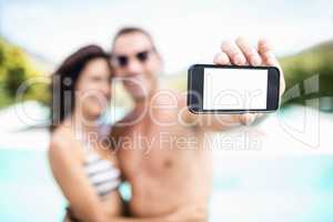 Young couple taking selfie with mobile phone