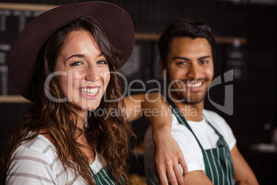 Smiling baristas looking at the camera