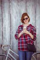 smiling hipster woman with coffee and a biycle