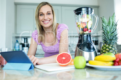 Pretty blonde woman using tablet computer