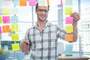 Hipster man looking at post-it