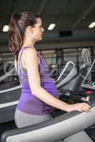 Pregnant woman exercising on a treadmill