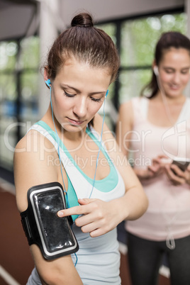 Smiling friends listening to music