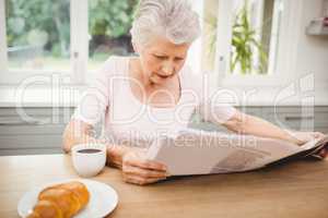 Senior woman reading a newspaper