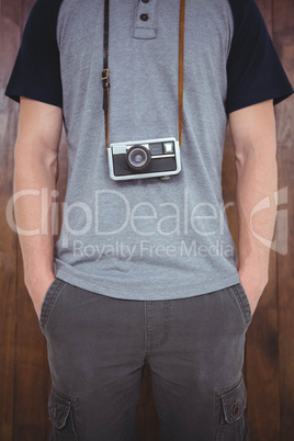 Handsome hipster holding retro camera
