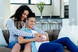Woman touching pregnant partners stomach