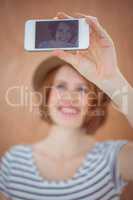 smiling hipster woman taking a selfie