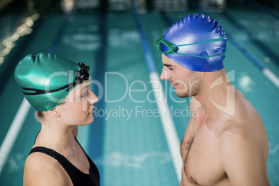 Couple in swimsuits looking at each others