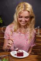 Smiling blonde enjoying a pastry