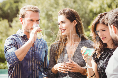 Happy young friends having drinks