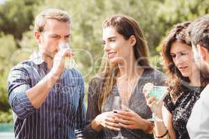 Happy young friends having drinks