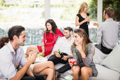 Group of friends talking and having drinks