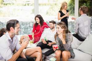 Group of friends talking and having drinks