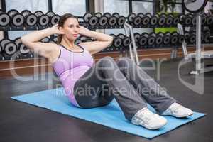 Woman doing abdominal crunches on mat