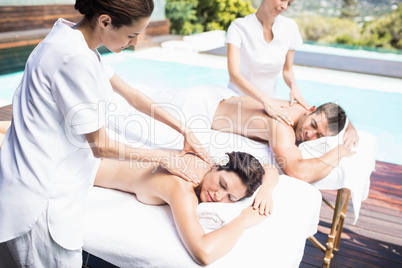 Young couple receiving a back massage from masseur