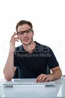 Handsome man using computer while drinking coffee