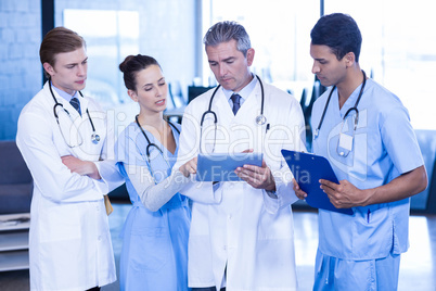 Doctors looking in digital tablet