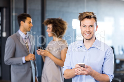 Confident executive using mobile phone