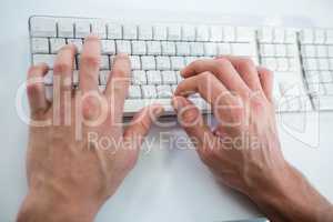Close up view of a male hand typing on keyboard