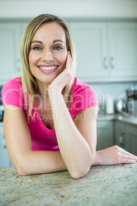 Pretty blonde woman leaning on the counter