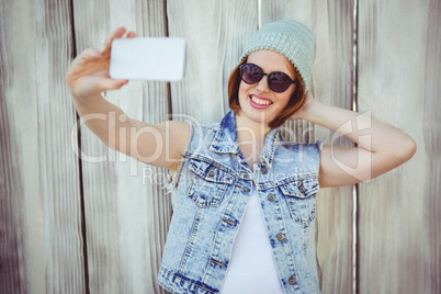 smiling hipster woman taking a selfie