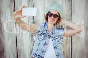 smiling hipster woman taking a selfie
