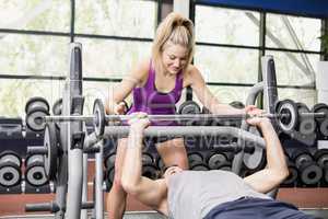 Trainer woman helping athletic man