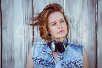 beautiful hipster woman wearing headphones and looking into the