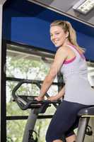 Fit woman doing exercise bike