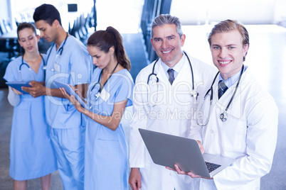 Medical team using laptop and digital tablet