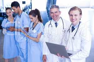 Medical team using laptop and digital tablet