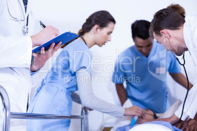 Doctor writing on clipboard