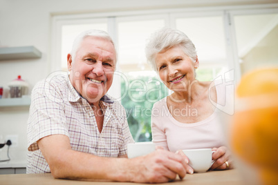 Portrait of senior couple smiling while having coffee