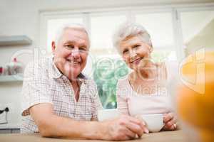 Portrait of senior couple smiling while having coffee